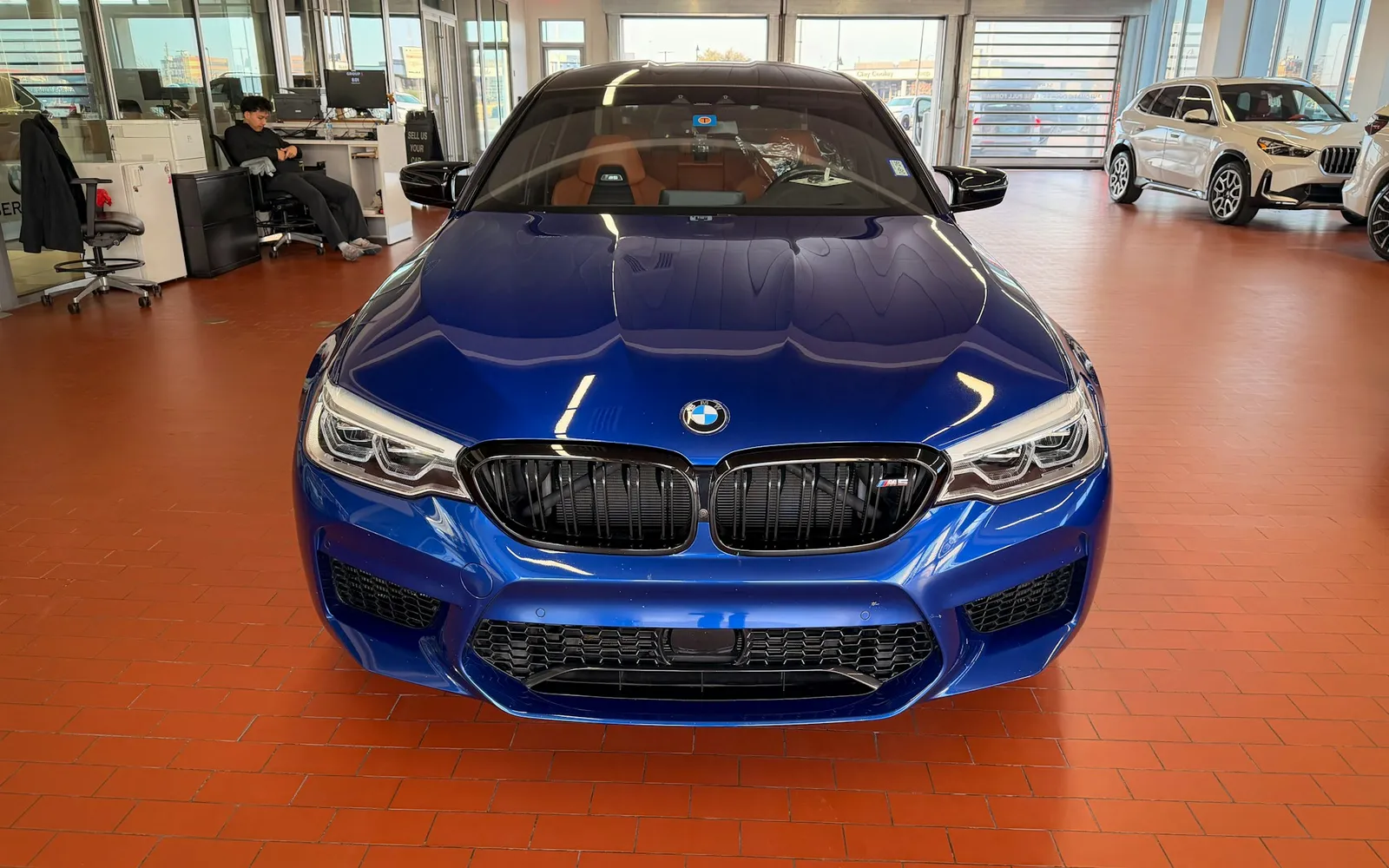 Blue car on display in a modern showroom