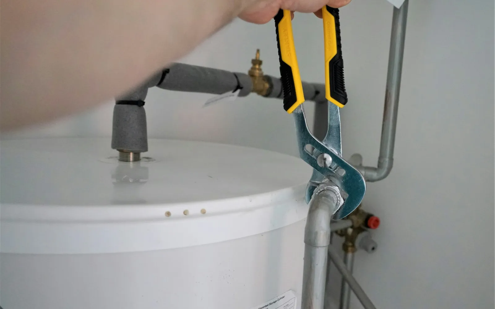 Plumber working on a home water heater